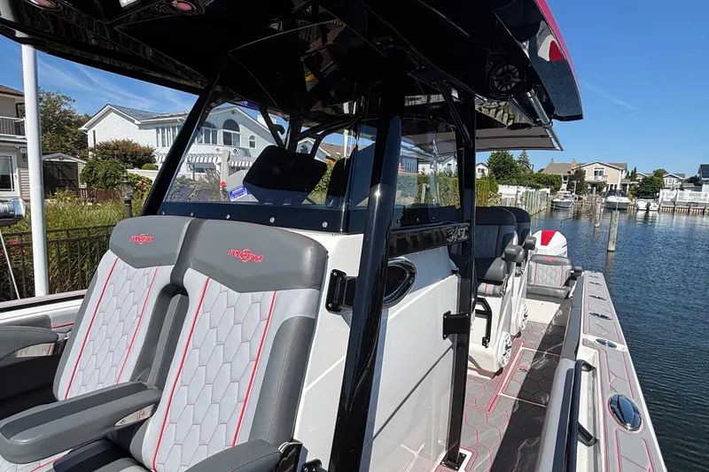 Slide: The Image of 2023 Fountain 34 SC boat interior with stylish seating and waterfront view. - 12