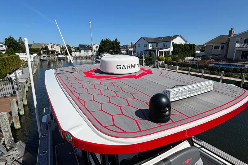 Slide: The Image of 2023 Fountain 34 SC boat with Garmin equipment docked in a residential canal. - 15