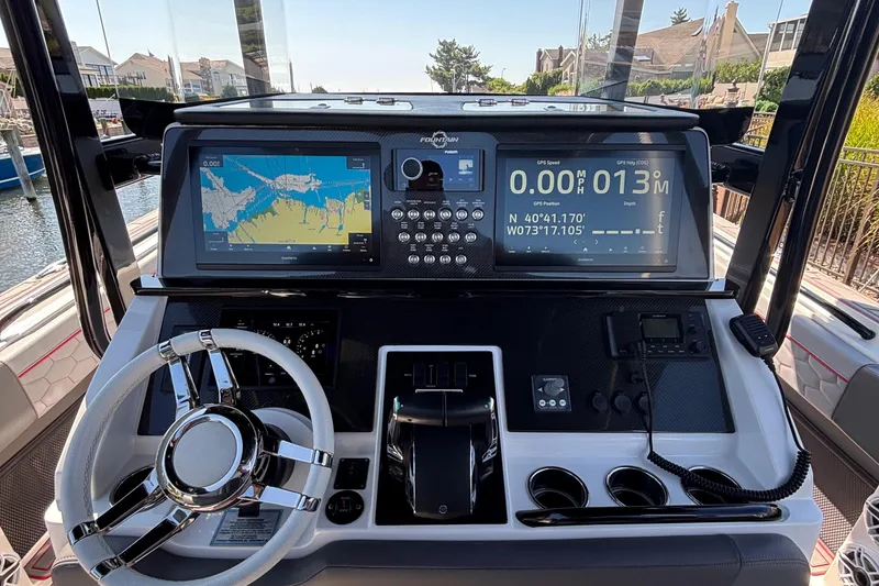 Slide: The Image of Cockpit of 2023 Fountain 34 SC boat with advanced navigation displays and controls. - 18