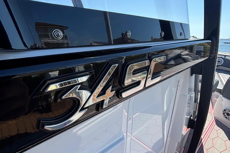 Slide: The Image of 2023 Fountain 34 SC boat emblem with sleek design and reflective finish. - 25