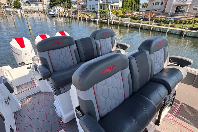 Slide: The Image of 2023 Fountain 34 SC boat interior with luxurious seating and waterfront view. - 28