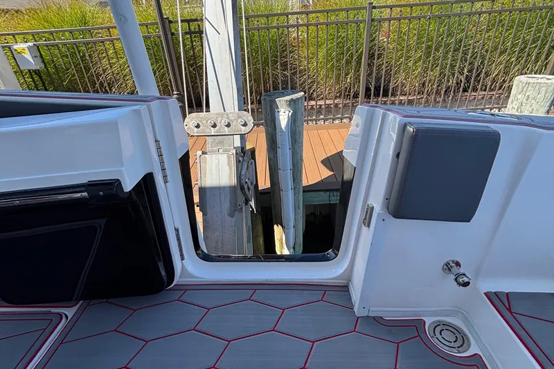 Slide: The Image of 2023 Fountain 34 SC boat interior with open door, dock view, and modern flooring. - 34