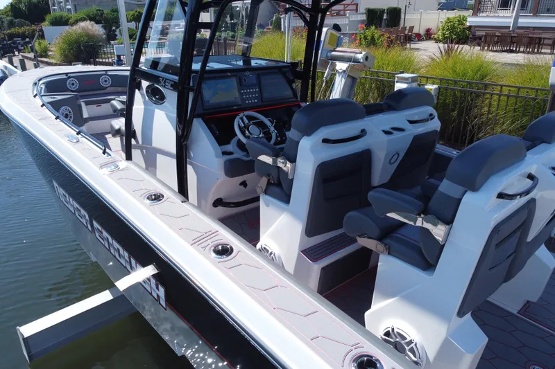 Slide: The Image of 2023 Fountain 34 SC boat interior with modern seating and navigation controls. - 42