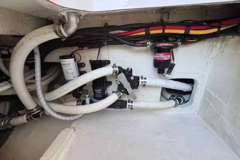 Slide: The Image of 2023 Fountain 34 SC boat engine compartment with hoses and fuel filter system. - 45