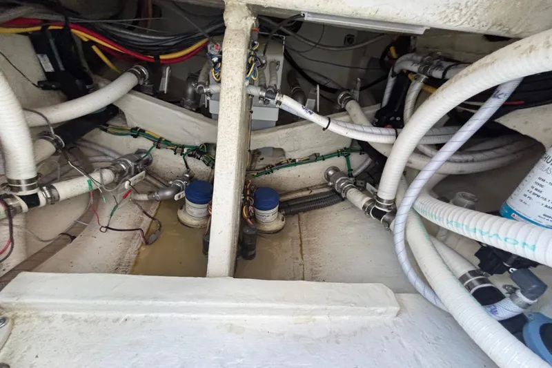 Slide: The Image of Engine compartment of 2023 Fountain 34 SC boat with visible wiring and plumbing. - 47