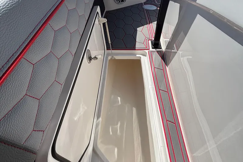 Slide: The Image of 2023 Fountain 34 SC boat interior with open storage compartment and hexagonal pattern upholstery. - 57