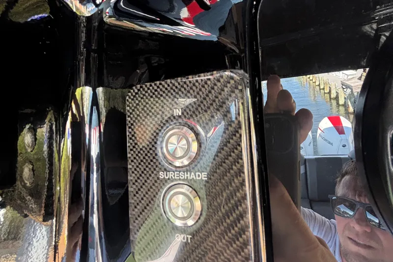 Slide: The Image of Control panel of 2023 Fountain 34 SC boat with SureShade buttons. - 64