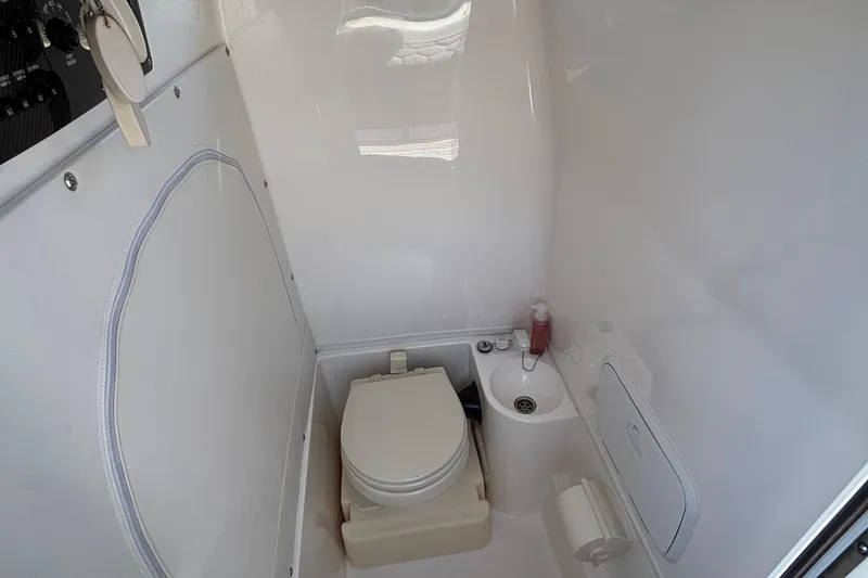 Slide: The Image of Compact bathroom in 2023 Fountain 34 SC boat with toilet and sink. - 65