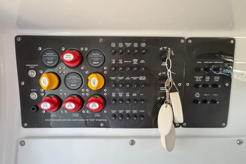 Slide: The Image of Control panel of 2023 Fountain 34 SC boat with switches and keys. - 66