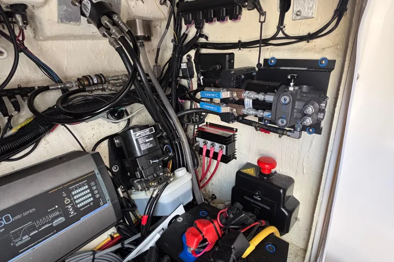 Slide: The Image of Engine compartment of 2023 Fountain 34 SC boat, showcasing wiring and hydraulic systems. - 68