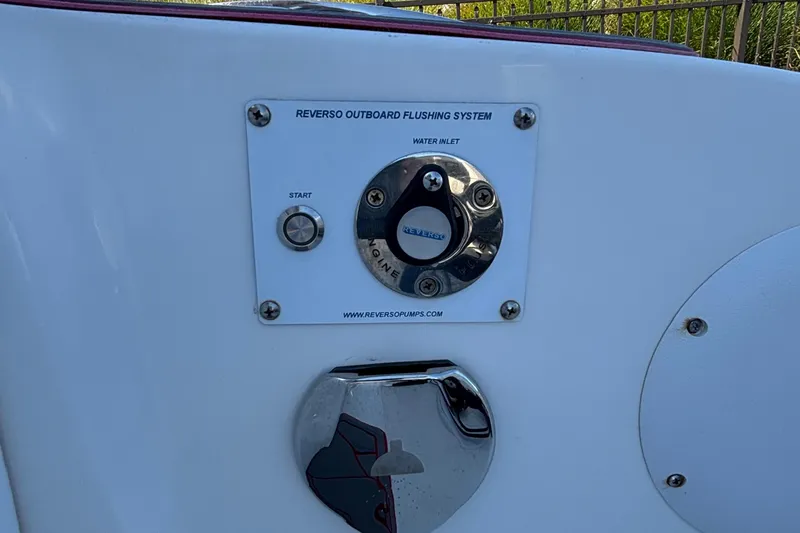 Slide: The Image of Reverso outboard flushing system on 2023 Fountain 34 SC boat, featuring water inlet and start button. - 71
