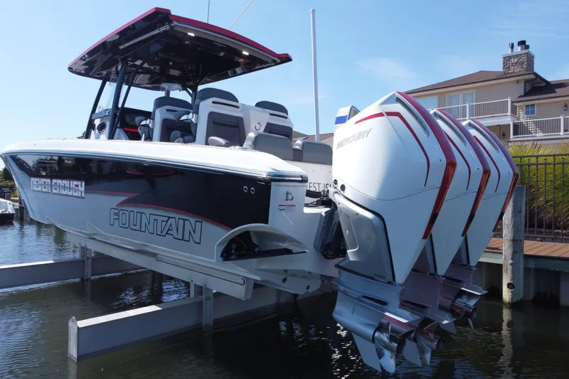 Slide: The Image of 2023 Fountain 34 SC boat with triple Mercury engines docked at marina. - 72