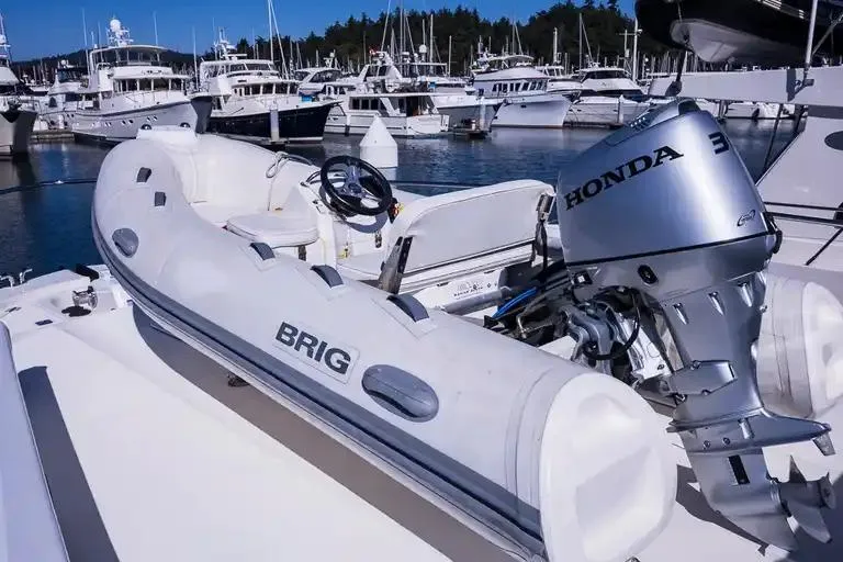 Slide: The Image of Inflatable boat with Honda motor on Maritimo M 51 yacht, 2017, in marina. - 11