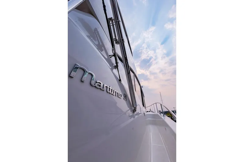 Slide: The Image of 2017 Maritimo M 51 yacht side view under a cloudy sky. - 13