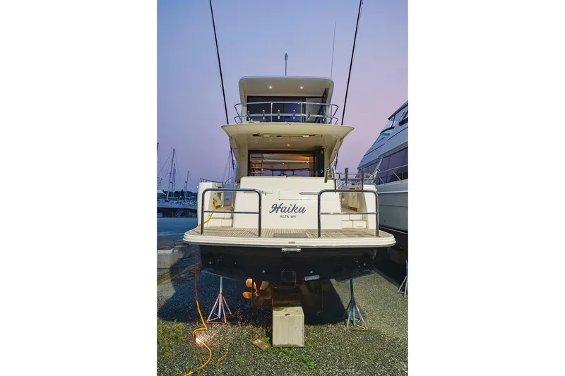 Slide: The Image of 2017 Maritimo M 51 yacht docked at sunset, rear view. - 14
