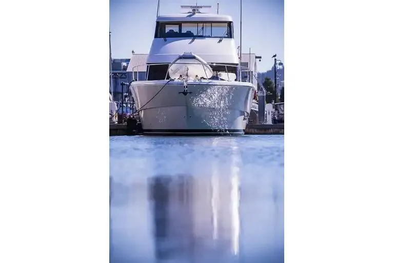 Slide: The Image of 2017 Maritimo M 51 yacht docked, reflecting on calm water. - 2