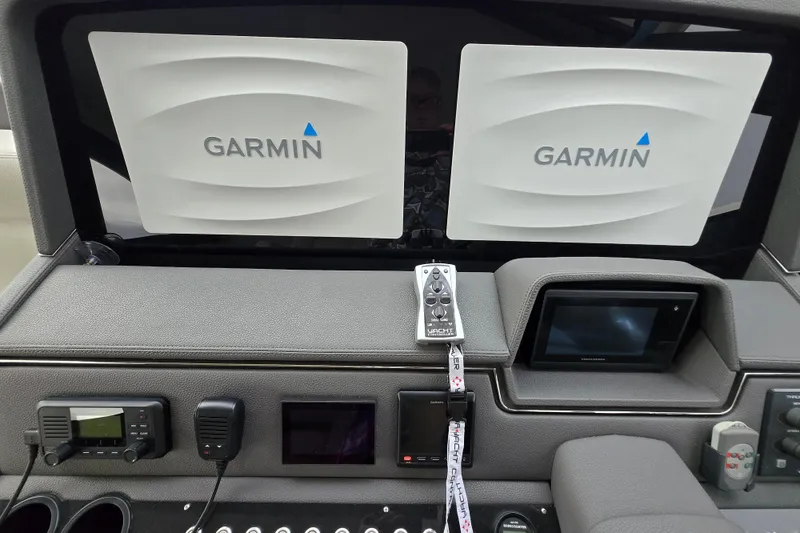 Slide: The Image of 2017 Maritimo M 51 yacht dashboard with Garmin navigation displays and controls. - 22