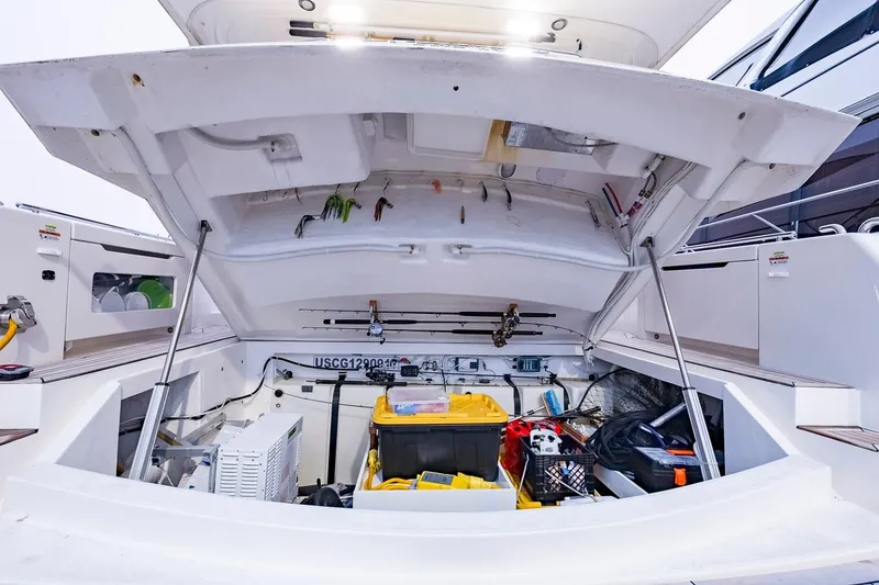Slide: The Image of Open storage compartment of 2017 Maritimo M 51 yacht, showcasing fishing gear and equipment. - 35
