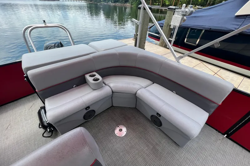 Slide: The Image of 2019 Bentley Pontoons 243 Cruise with gray seating, cup holders, and lake view. - 10