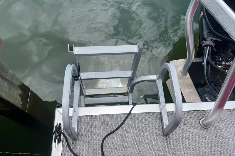 Slide: The Image of 2019 Bentley Pontoons 243 Cruise ladder and deck by the water. - 4