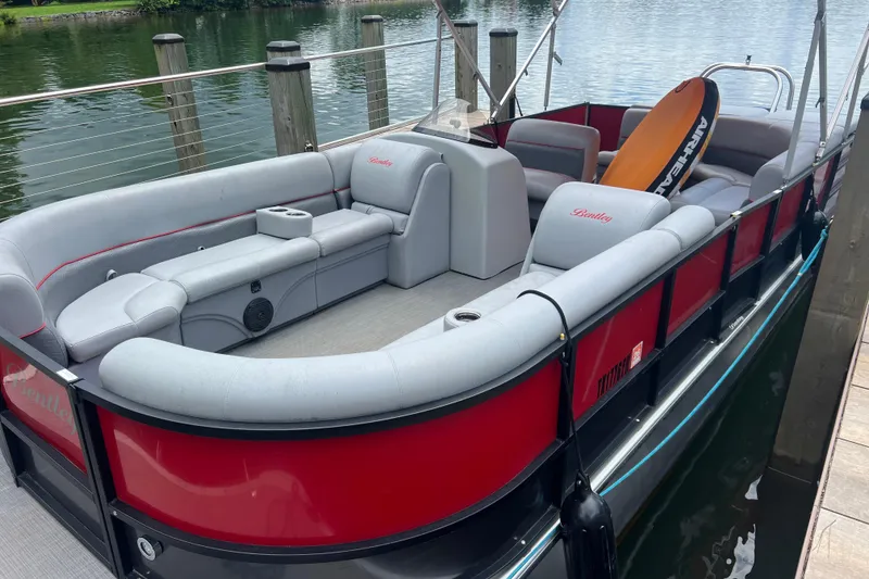 Slide: The Image of 2019 Bentley Pontoons 243 Cruise with luxurious seating, docked by a serene lake. - 5