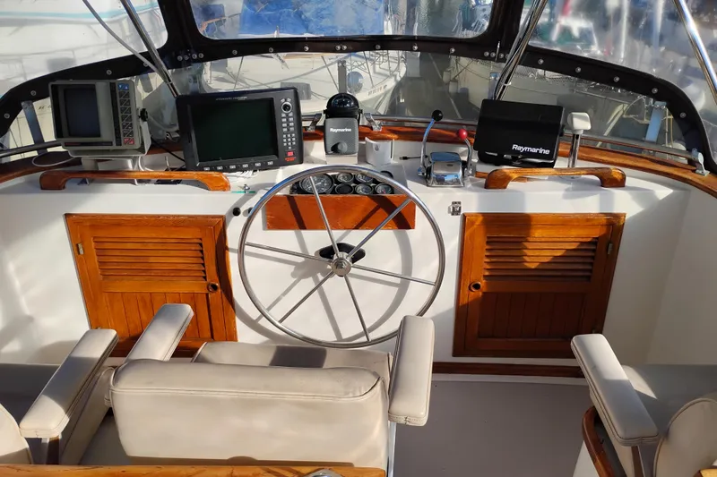 Slide: The Image of 1988 Monk 36 Aft Cabin helm with navigation equipment and wooden accents. - 10