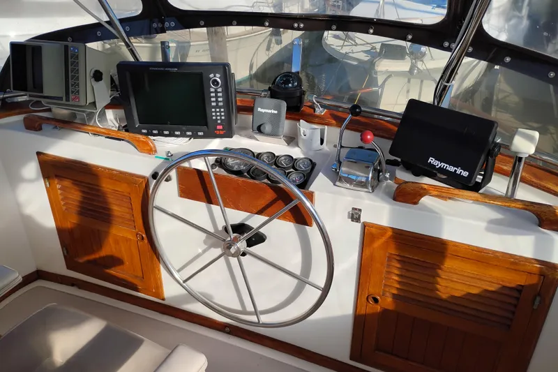 Slide: The Image of 1988 Monk 36 Aft Cabin helm with navigation equipment and wooden accents. - 11