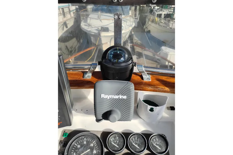Slide: The Image of 1988 Monk 36 Aft Cabin helm with Raymarine equipment and compass. - 12