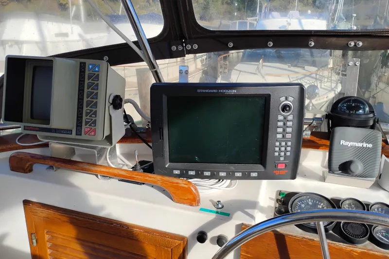 Slide: The Image of 1988 Monk 36 Aft Cabin helm with navigation equipment and steering wheel. - 13