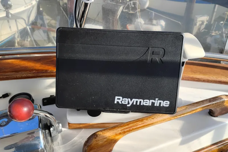 Slide: The Image of Raymarine device on 1988 Monk 36 Aft Cabin boat, featuring wooden and metal details. - 15
