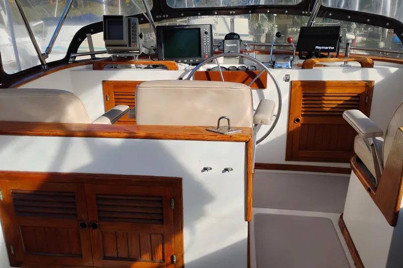 Slide: The Image of 1988 Monk 36 Aft Cabin helm with wooden accents and navigation equipment. - 17