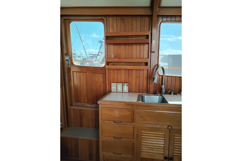 Slide: The Image of 1988 Monk 36 Aft Cabin interior with wooden cabinetry and sink. - 25