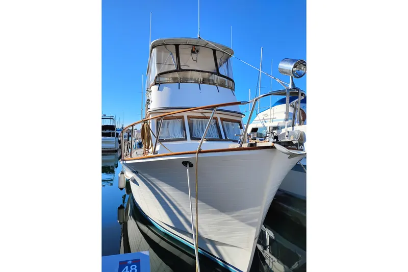Slide: The Image of 1988 Monk 36 Aft Cabin boat docked under clear blue sky. - 3