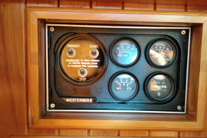 Slide: The Image of Control panel of a 1988 Monk 36 Aft Cabin boat with gauges and switches. - 32