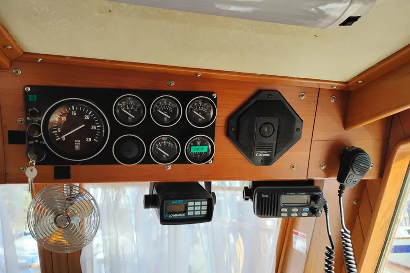 Slide: The Image of Control panel of a 1988 Monk 36 Aft Cabin boat with gauges and communication devices. - 35