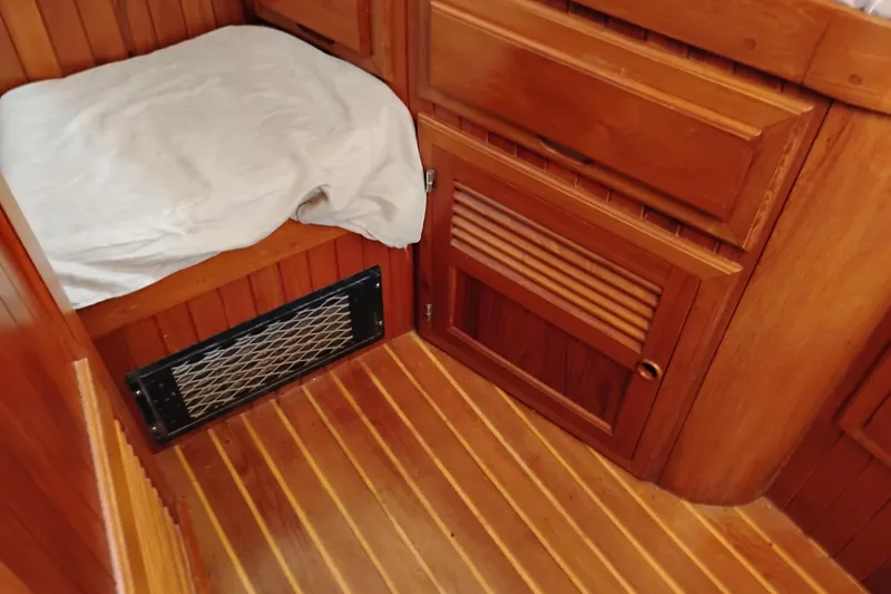 Slide: The Image of 1988 Monk 36 Aft Cabin interior with wooden cabinetry and flooring. - 39