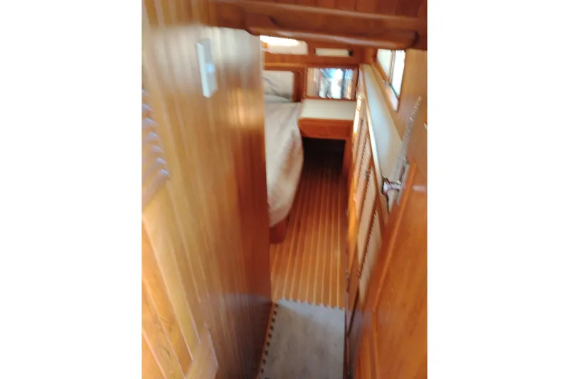 Slide: The Image of 1988 Monk 36 Aft Cabin interior with wooden paneling and cozy bed. - 45
