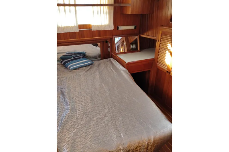 Slide: The Image of Cozy cabin interior of 1988 Monk 36 Aft Cabin with wooden paneling and bed. - 47