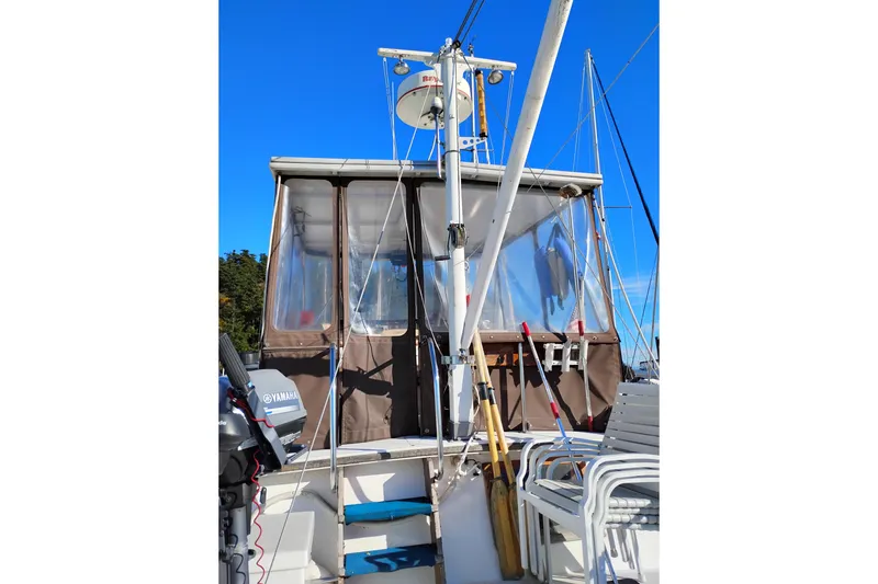 Slide: The Image of 1988 Monk 36 Aft Cabin boat with Yamaha motor, docked under clear blue sky. - 5