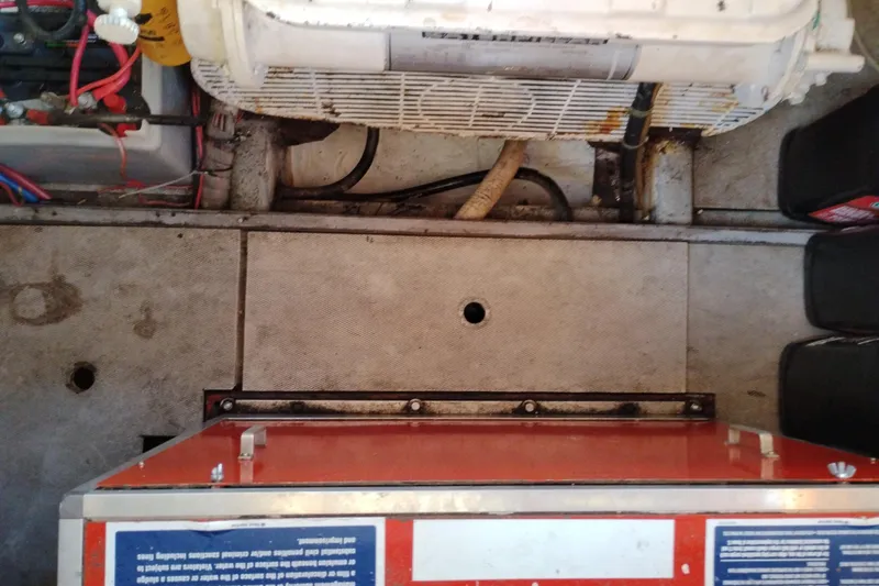 Slide: The Image of Engine room of 1988 Monk 36 Aft Cabin with visible wiring and equipment. - 62