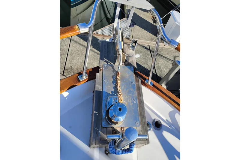 Slide: The Image of 1988 Monk 36 Aft Cabin boat anchor system with polished metal and wood details. - 65