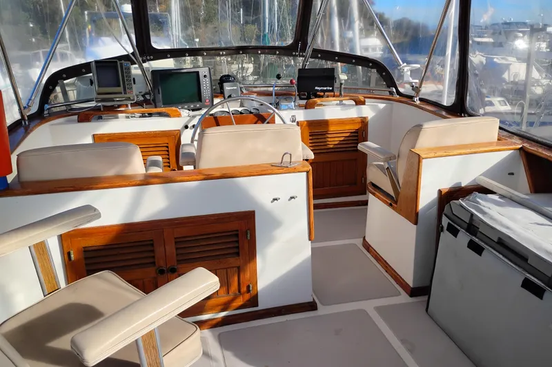Slide: The Image of 1988 Monk 36 Aft Cabin yacht interior with helm, seating, and navigation equipment. - 8