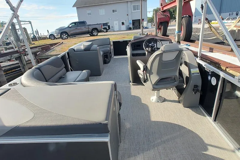 Slide: The Image of 2023 Tahoe Pontoon LTZ Entertainer boat interior with seating and steering console. - 10