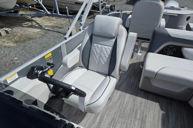 Slide: The Image of 2026 Godfrey Sweetwater 2286 FS boat interior with luxurious seating and steering controls. - 14