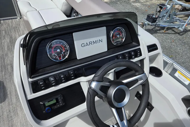 Slide: The Image of 2026 Godfrey Sweetwater 2286 FS boat dashboard with Garmin display and steering wheel. - 15