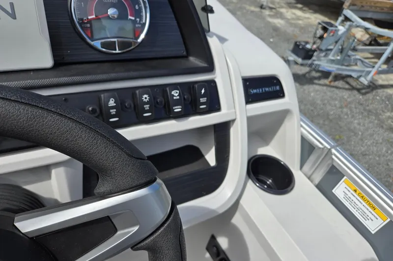 Slide: The Image of 2026 Godfrey Sweetwater 2286 FS dashboard with steering wheel and control panel. - 18