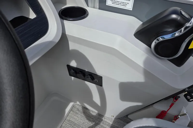 Slide: The Image of Control panel of 2026 Godfrey Sweetwater 2286 FS boat with cup holder and throttle. - 19