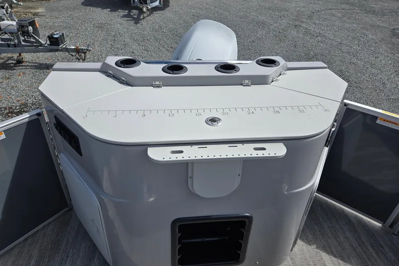 Slide: The Image of 2026 Godfrey Sweetwater 2286 FS boat console with cup holders and measurement markings. - 24