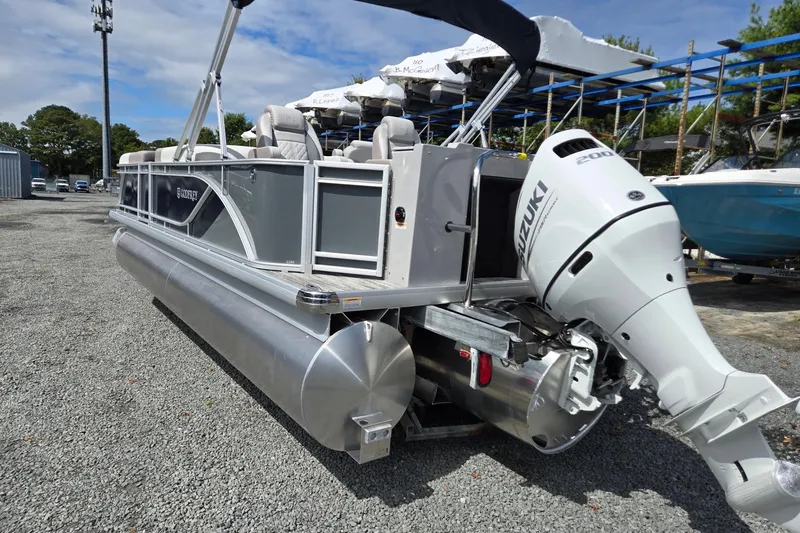Slide: The Image of 2026 Godfrey Sweetwater 2286 FS pontoon boat with Suzuki engine on gravel lot. - 3