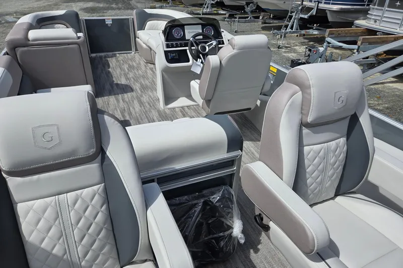 Slide: The Image of 2026 Godfrey Sweetwater 2286 FS pontoon boat interior with luxurious seating and modern dashboard. - 31